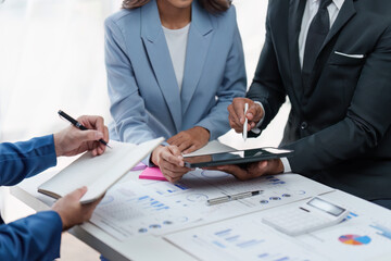 Close up of Diverse colleagues gather brainstorm discuss financial statistics at office meeting. finance, teamwork, Big data Graphs Charts concept