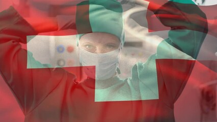 Animation of flag of switzerland over caucasian female surgeon with face mask - Powered by Adobe