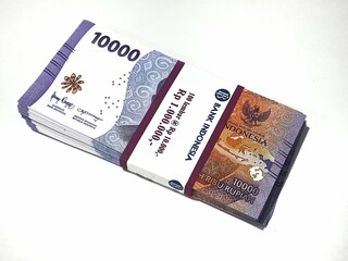 Fototapeta premium Isolated photo of a wad or a stack or a bundle of ten thousand rupiah bills in new and very good condition