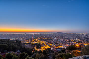 View over Barcelona before sunrise with the Mediterranean Sea in the back