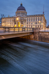 The rebuilt Berlin City Palace with a small canal at dusk