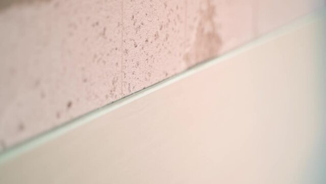 Plasterboard sheet streaked on an aerated concrete wall, close-up. Moisture resistant drywall