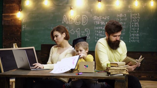 Father and mother teach lovely son to draw and paint. Kids learning and education concept. Happy family. Mother father and son together schooling. Boy from elementary school.