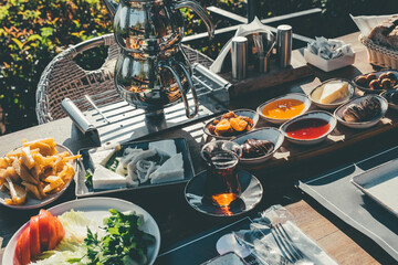 Turkish breakfast table. Rich breakfast served on the terrace on sunny morning.
