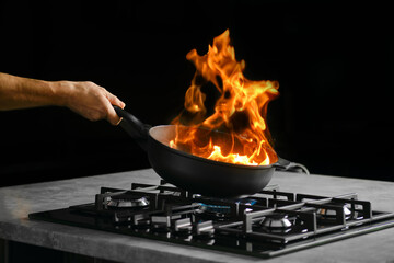 Flambering food ingredients in a frying pan