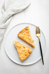 Two pieces of homemade apple pie with nuts on a plate