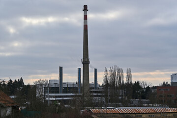 Fototapeta na wymiar Heating plant with an old unused chimney and three new chimneys