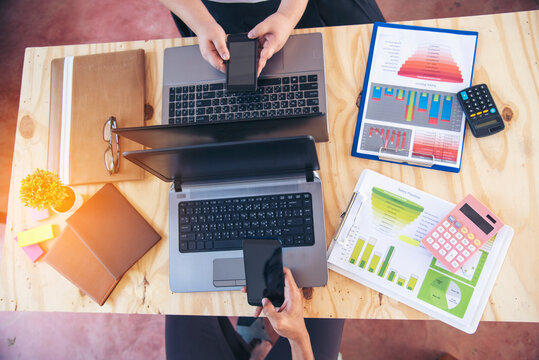 Two businesspeople meeting work at office desk. Teamwork partners team with Business strategy chart graph, infographic data financial report. Team partner planning marketing finance excel stat report
