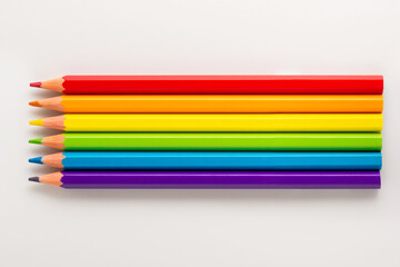 Fototapeta premium top view of concept gay culture symbol with pencils like rainbow, sign gay LGBT community, close up