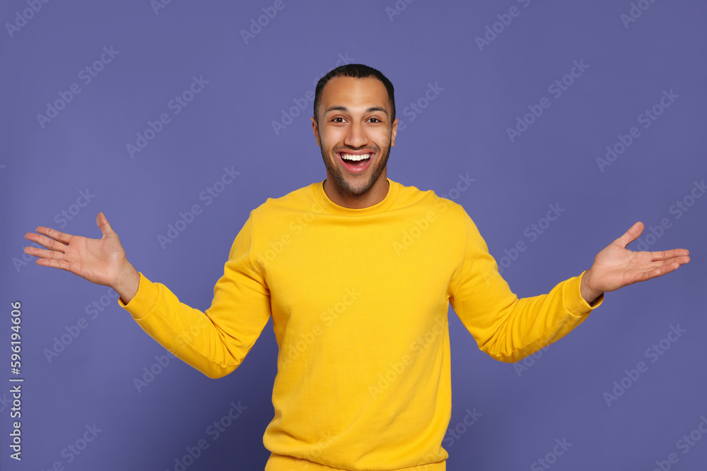 Poster Portrait of happy African American man on purple background