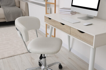 Workplace with comfortable office chair indoors. Interior design