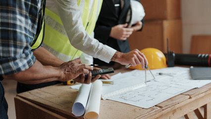 Architect or engineer are designing house, modifying plan, creating construction project and addition according to customer requirement.