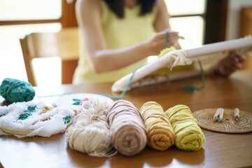 Fototapeta na wymiar Punch needle. Asian Woman making handmade Hobby knitting in studio workshop. designer workplace Handmade craft project DIY embroidery concept.