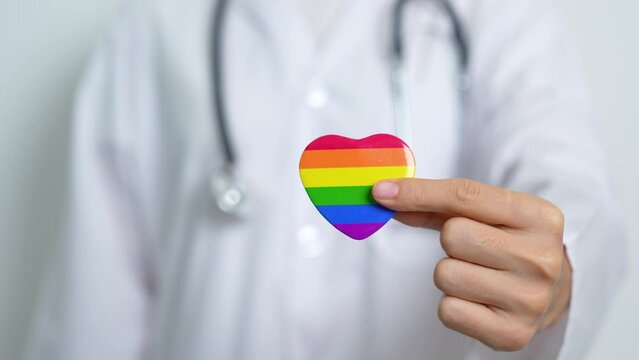 LGBT pride month or LGBTQ+ or LGBTQIA+ and health concept. Doctor with rainbow and colorful heart shape with for Lesbian, Gay, Bisexual, Transgender, Queer and Pansexual community