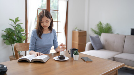 .Young asian woman reading a book at home, girl hold book Education school university college concept.concept.