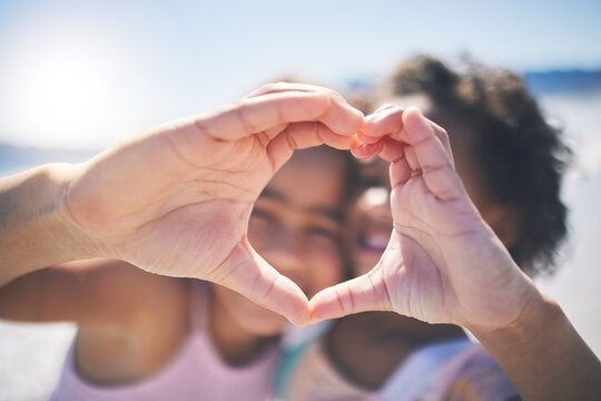 Happy, outdoor and girls with heart hands, support and wellness on break, relax or bonding. Friends, young people or children with happiness, symbol for love or emoji with care, solidarity or outside