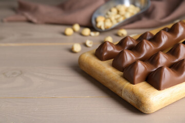 Tasty chocolate bars on wooden table, space for text
