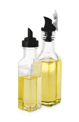 Glass bottles of cooking oil on white background