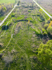 Green abandoned motocross track seen from the top