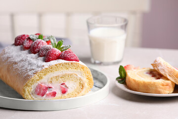 Delicious cake roll with strawberries and cream on light gray table