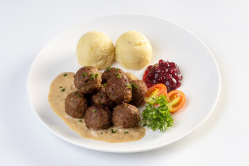 Swedish meatballs with creamy gravy, mashed potatoes and lingonberry sauce.