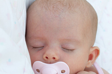 Close up of a newborn baby sleeping calm with pacifier