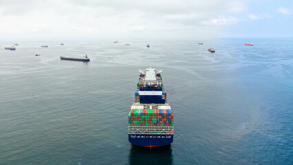 Aerial view of blue hull color ultra large container ship in discharged condition at anchor near...