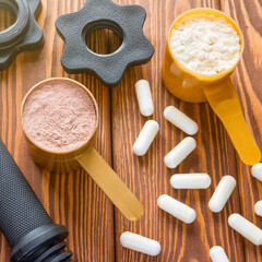 dumbbell neck and measuring spoons with protein closeup