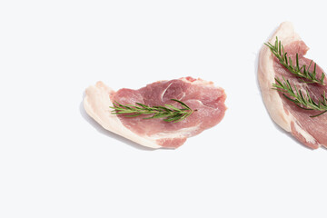 Pork meat with rosemary on white background.