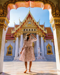 women walking at Wat Benchamabophit temple in Bangkok Thailand, The Marble temple in Bangkok - obrazy, fototapety, plakaty