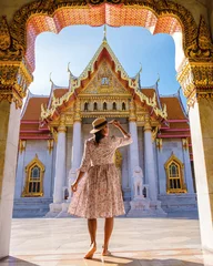 Poster de jardin Bangkok women walking at Wat Benchamabophit temple in Bangkok Thailand, The Marble temple in Bangkok