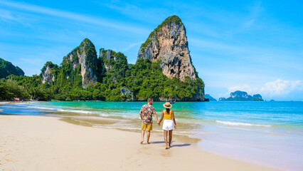 Fototapeta premium Railay beach Krabi Thailand, couple of men and women on the beach of tropical beach of Railay Krabi