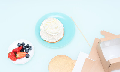 Ingredients for Pavlova cake: strawberries, blueberries and meringue with selective focus. Homemade pastry, delicious sweets concept