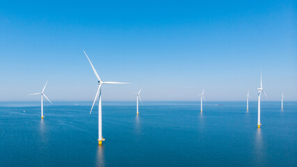 Windmill park in the ocean, drone aerial view of windmill turbines generating green energy electric, windmills isolated at sea in the Netherlands © Chirapriya