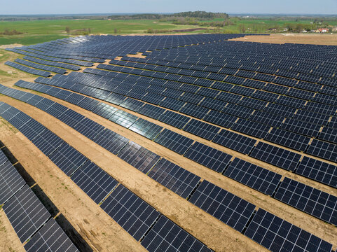 Drone photography of solar farm and green fields, solar power plant in Poland, aerial photo photovoltaic power station on sunny day