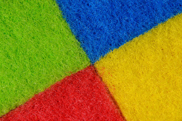 Tło tekstura struktura gąbki w czterech podstawowych kolorach - żółty, zielony, niebieski i czerwony - obrazy, fototapety, plakaty