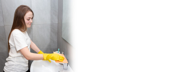 Young woman cleans the bathroom with rubber gloves Home cleaning routine at home. Frequency...