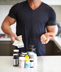 Closeup, cash and man with pills, supplements and vitamins at home, growth and muscle development. Zoom, male person and healthy model with fitness, money and medicine for body care, drugs and bills