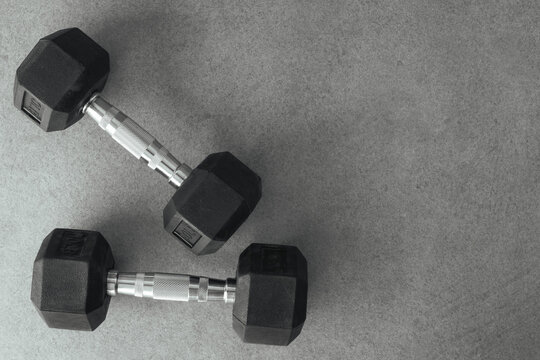 Two dumbbells on concrete