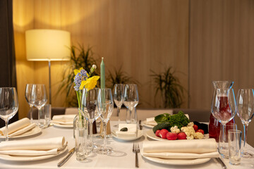 White color table decorated with decorative and elegant for wedding. serving plates on the restaurant table.
