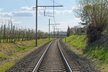 Railway lines perspective countryside in the middle of railway tracks. spring sky
