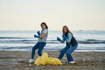Environmentalists dancing by plastic bags at beach