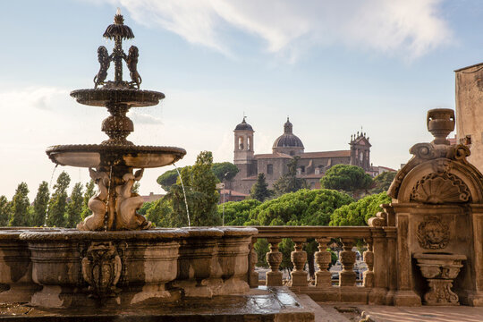 Italy, Lazio, Viterbo, Fountain and terrace of Palazzo dei Priori with Chiesa della Santissima Trinita church in background