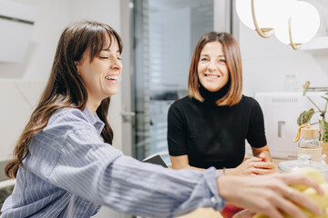 Happy nutritionist with client at home