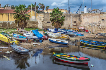 Fototapeta na wymiar Fishing boats in port of Syracuse town, Sicily Island, Italy