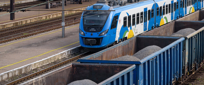 BIALOGARD, WEST POMERANIAN - POLAND - 2022: Regional train and freight train at the railway station
