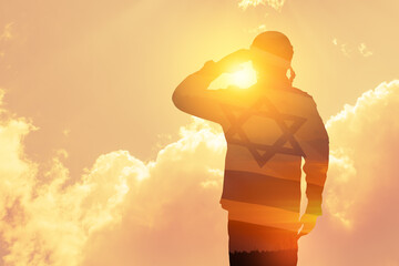 Double exposure of Silhouette of a solider and the sunset or the sunrise against Israel flag.