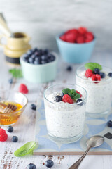 Greek yogurt in glasses with berries and quinoa