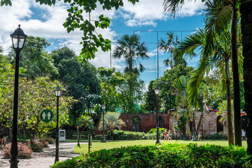 Fototapeta na wymiar The lush gardens at Fort Santiago,with palm trees and retro street lamps,Intramuros,Manila,The Philippines.