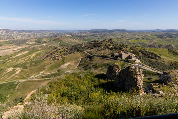 Naklejka premium Craco, Basilicata. Abandoned city. A ghost town built on a hill and abandoned due to geological problems. Surreal look, horror film scenery. Panorama of the Calanchi Park.